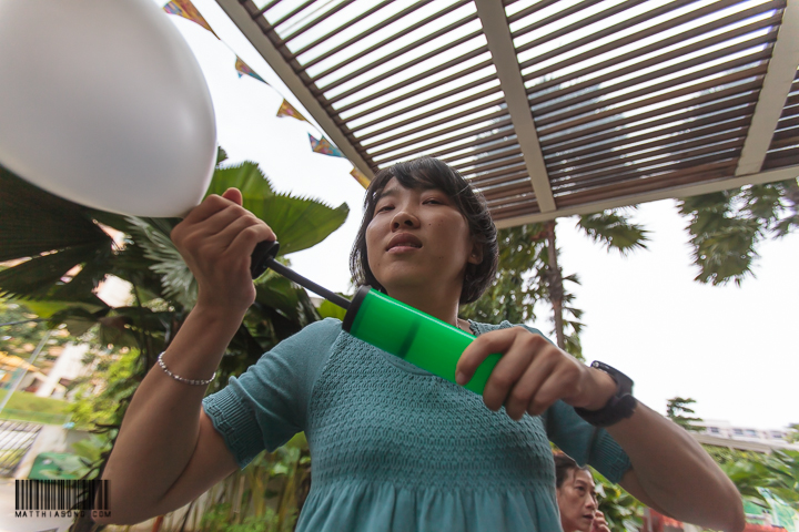 Yiyi helping to pump balloons